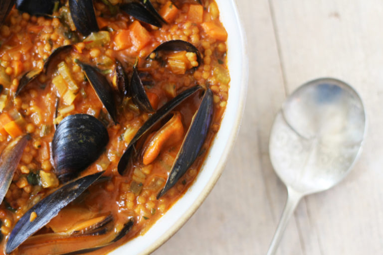 A bowl of maftoul with mussels